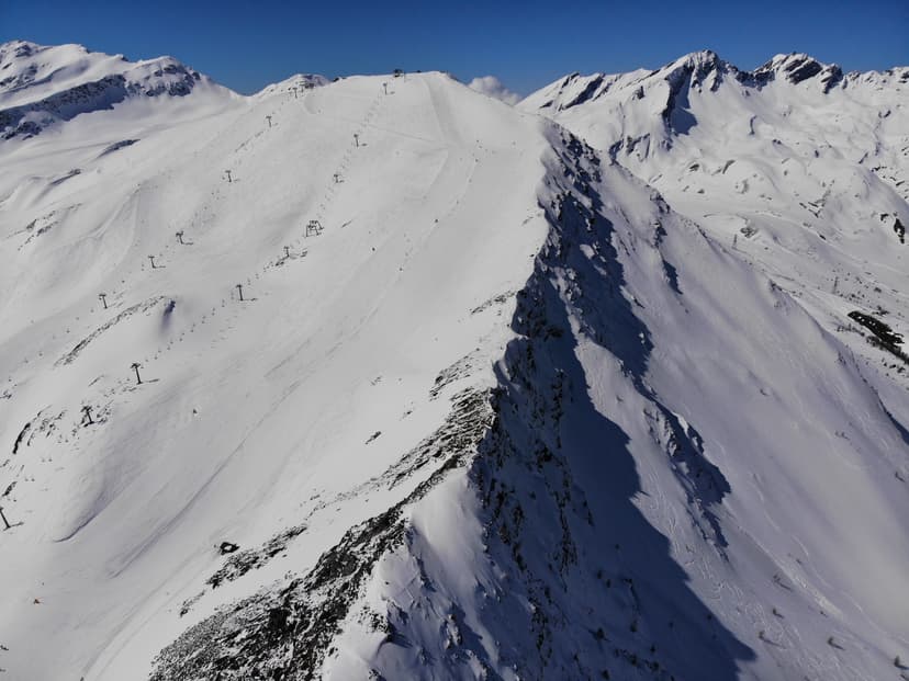 Chairlift and ski slope on mountain ridge