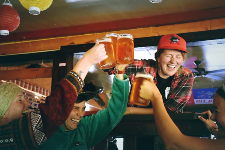 Skies enjoying apres ski party with beers